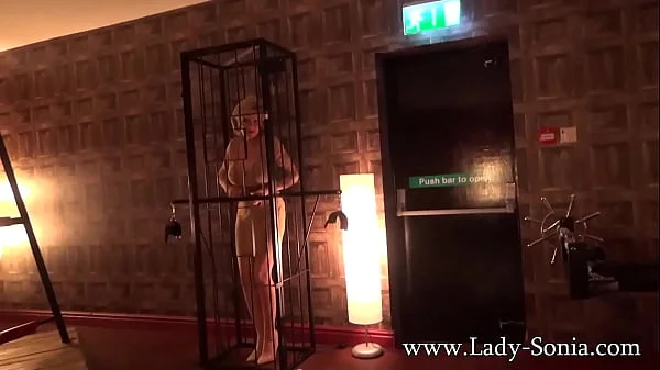 Lady Sonia caged and strips nude in the sex dungeon